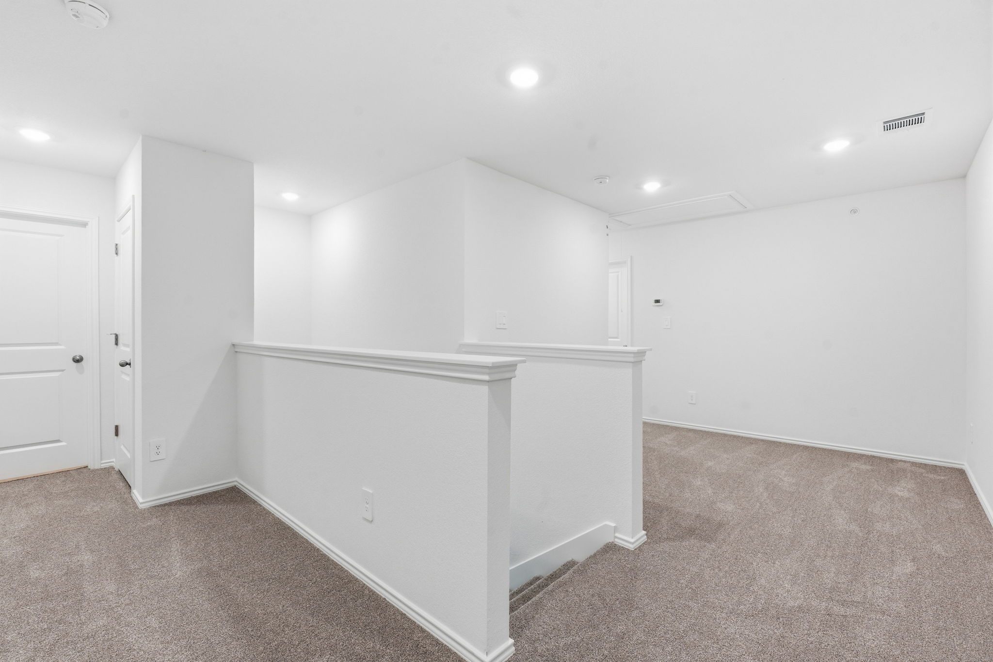 164 Cinnabar Lane, Unit 5 Kyle, TX 78640 - Photo 10 of 21 Spacious loft area featuring neutral carpeting, white painted walls, recessed lighting, and white trim