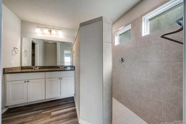 a bathroom with a double vanity sink and a mirror