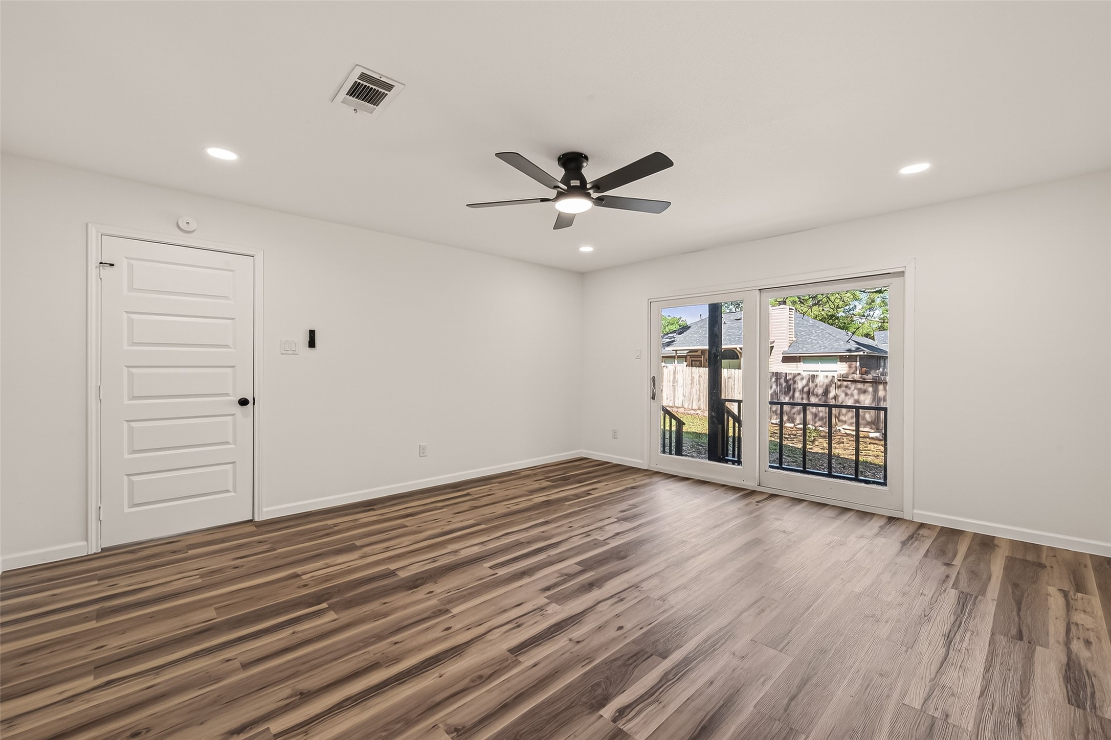 2915 Whispering Springs Drive Spring, TX 77373 - Photo 28 of 36 Large bedroom featuring updated flooring, ceiling fan, and access to private outdoor space.