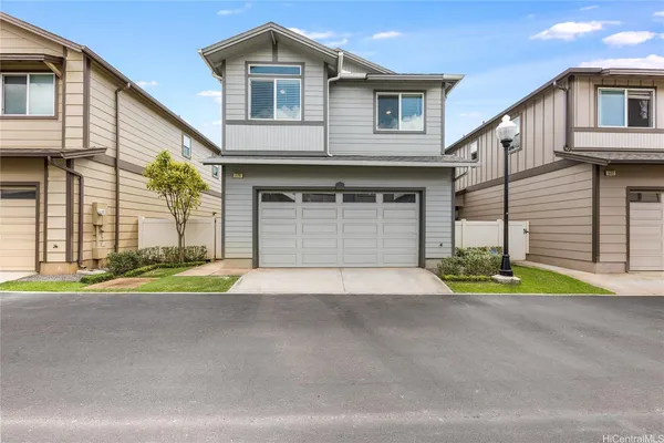 a front view of a house with a yard and a garage