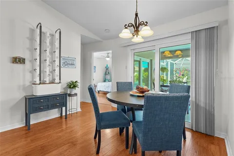 a view of a dining room with furniture wooden floor and a chandelier