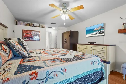 a bedroom with a bed and a chandelier