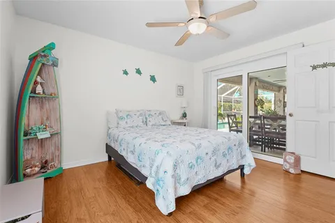 a living room with patio furniture and garden view