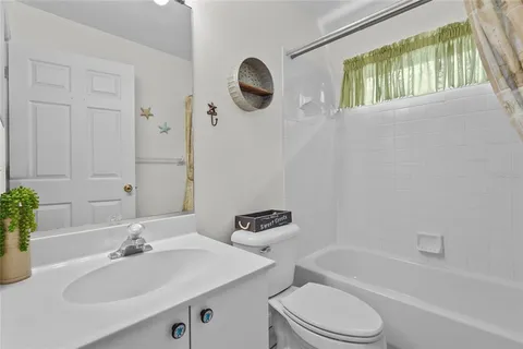 a living room with fireplace furniture and a floor to ceiling window