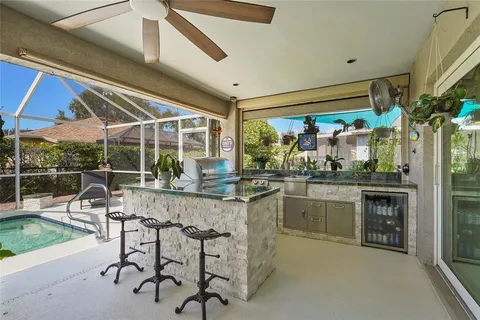 a view of a patio with a table and chairs under an umbrella