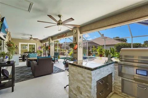 a dining room with furniture and a floor to ceiling window