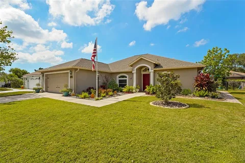 a front view of a house with yard and swimming pool