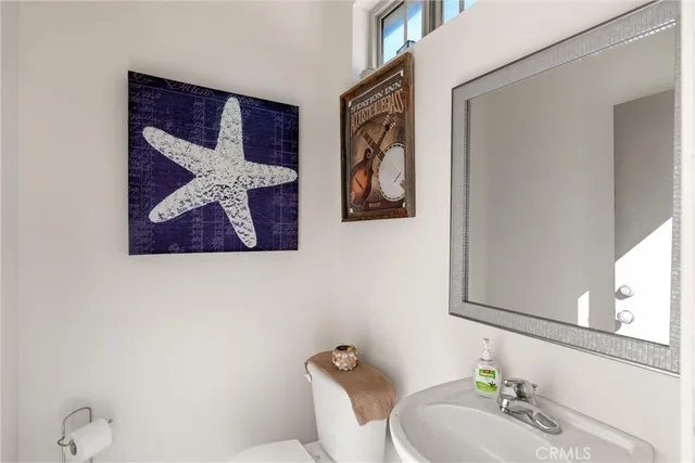 a hallway with stairs and wooden floor