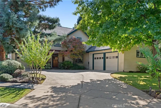a front view of a house with a yard and a garage