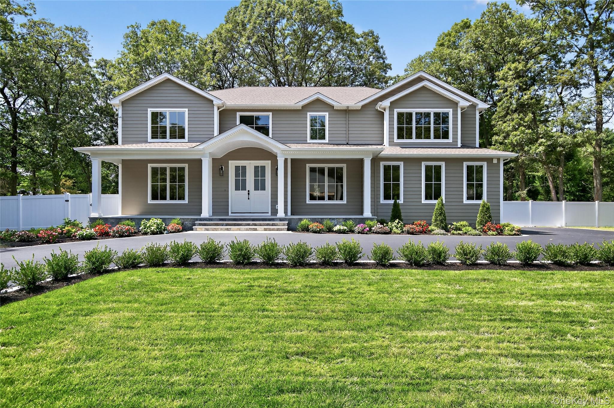 View of front of property featuring covered porch and a shingled roof