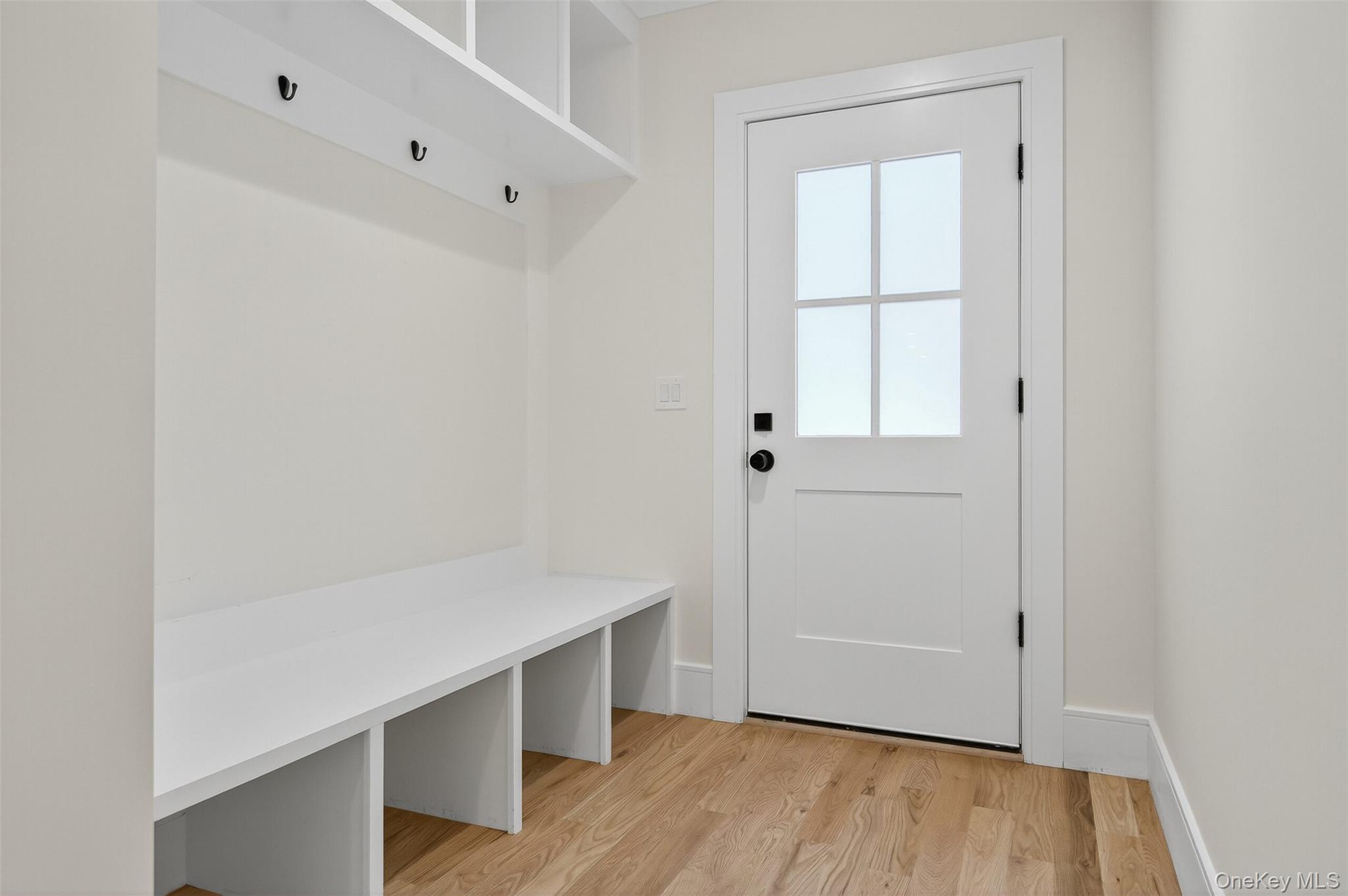 654 Caledonia Road Dix Hills, NY 11746 - Photo 17 of 42 Mudroom with light wood-style floors and baseboards