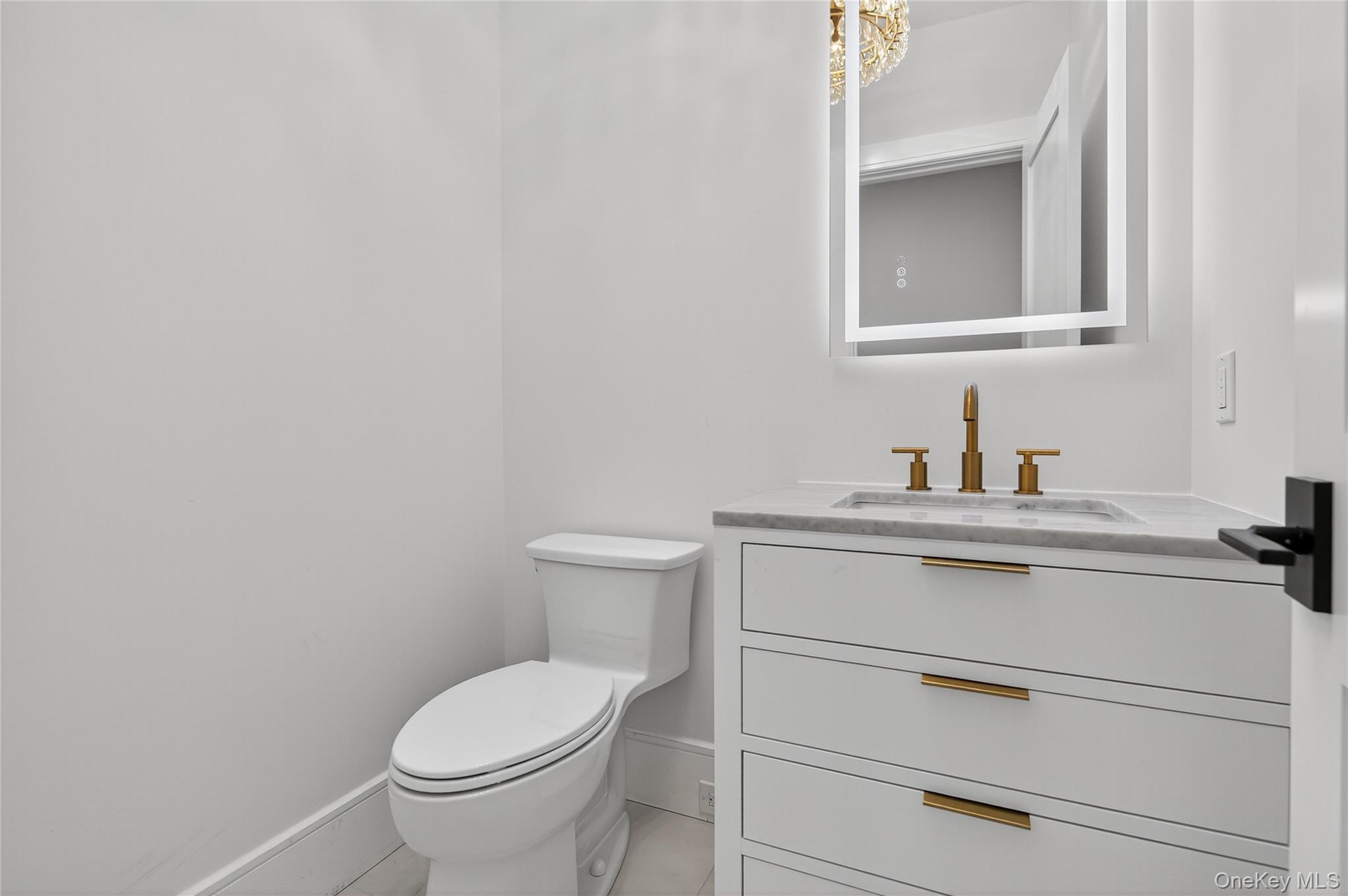 654 Caledonia Road Dix Hills, NY 11746 - Photo 18 of 42 Half bath with vanity and light tile patterned floors