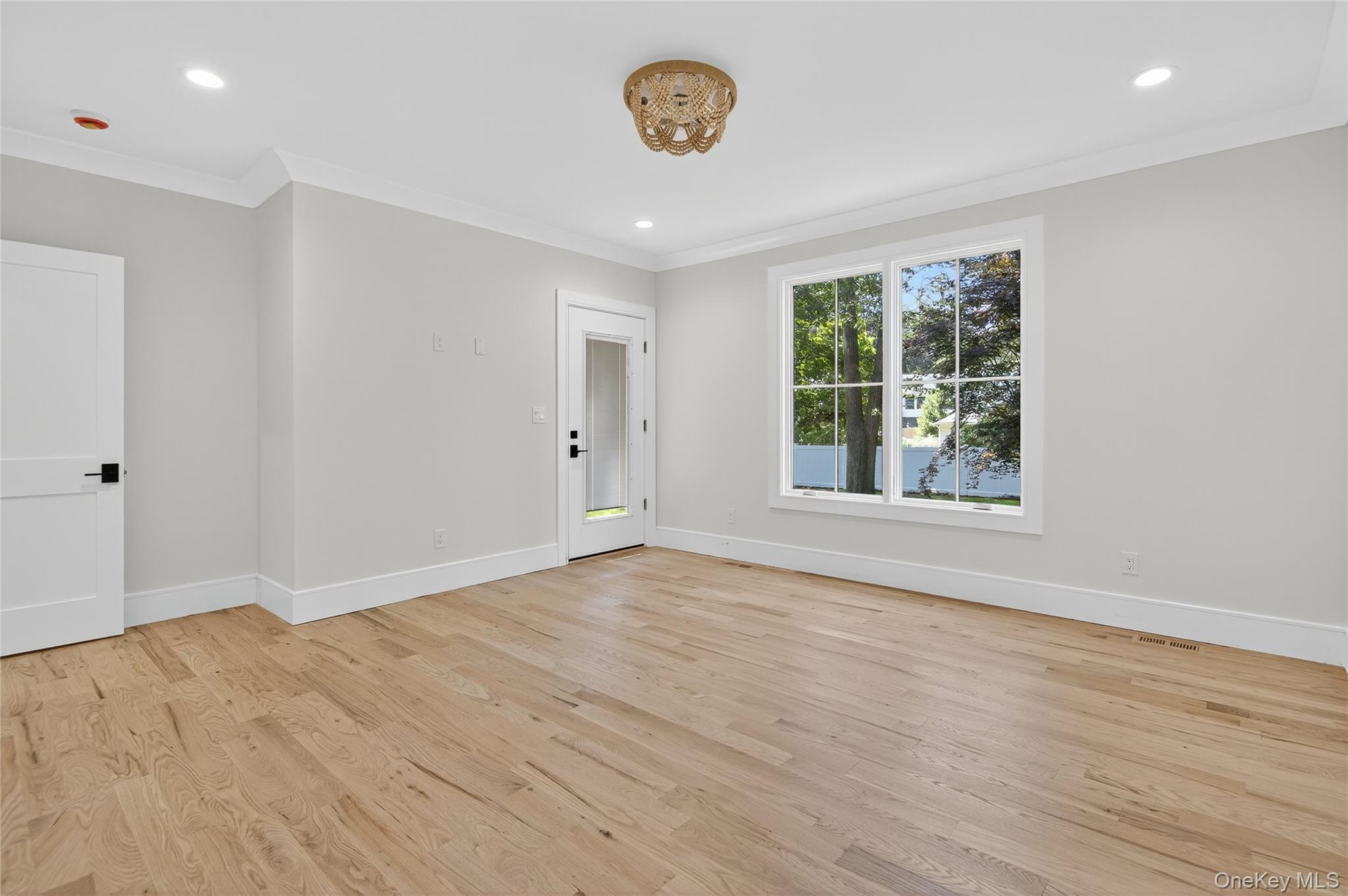 654 Caledonia Road Dix Hills, NY 11746 - Photo 19 of 42 Spare room with light wood-style flooring, recessed lighting, and crown molding