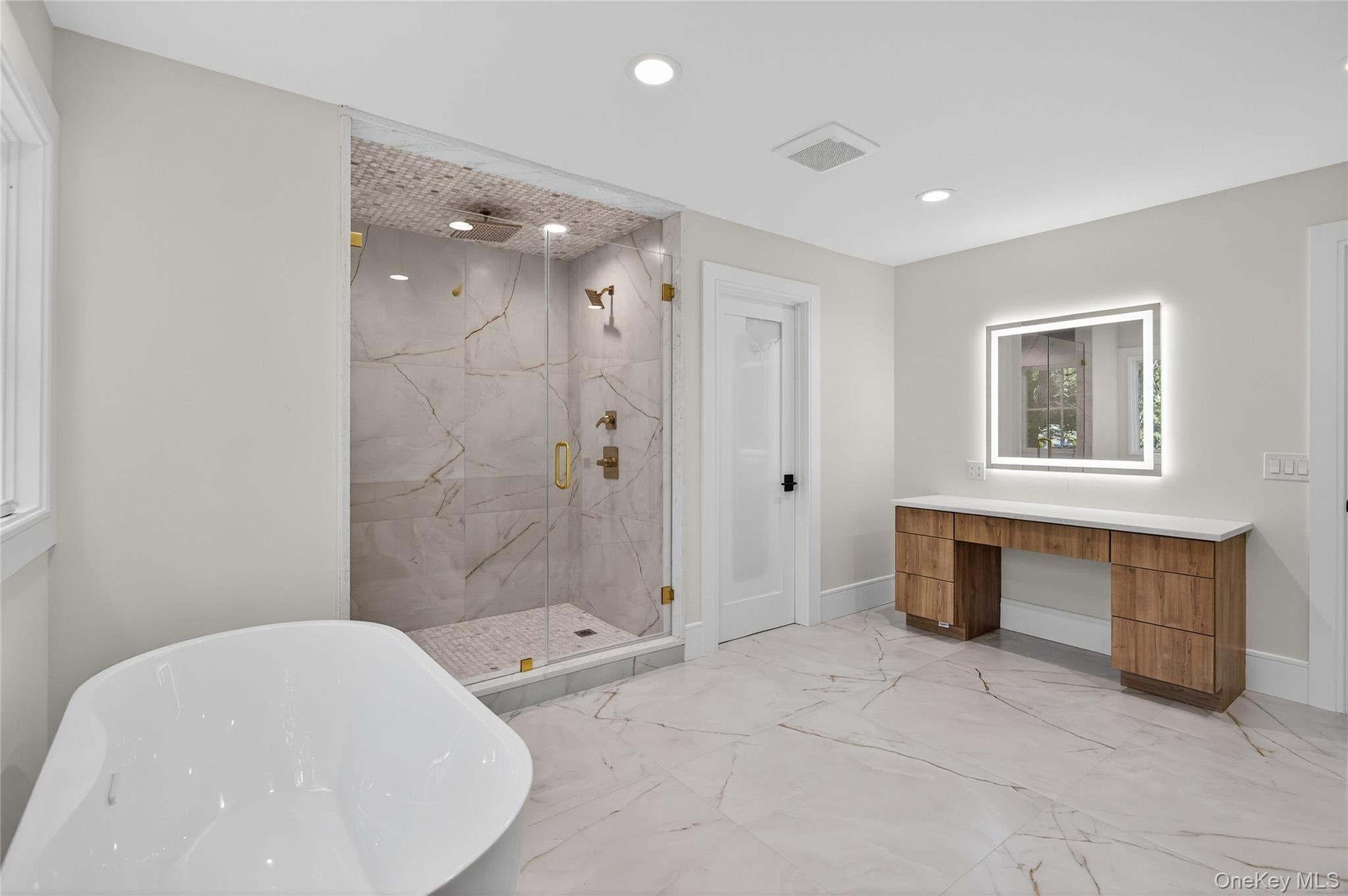 654 Caledonia Road Dix Hills, NY 11746 - Photo 25 of 42 Full bath with light marble finish flooring, a soaking tub, a marble finish shower, and recessed lighting