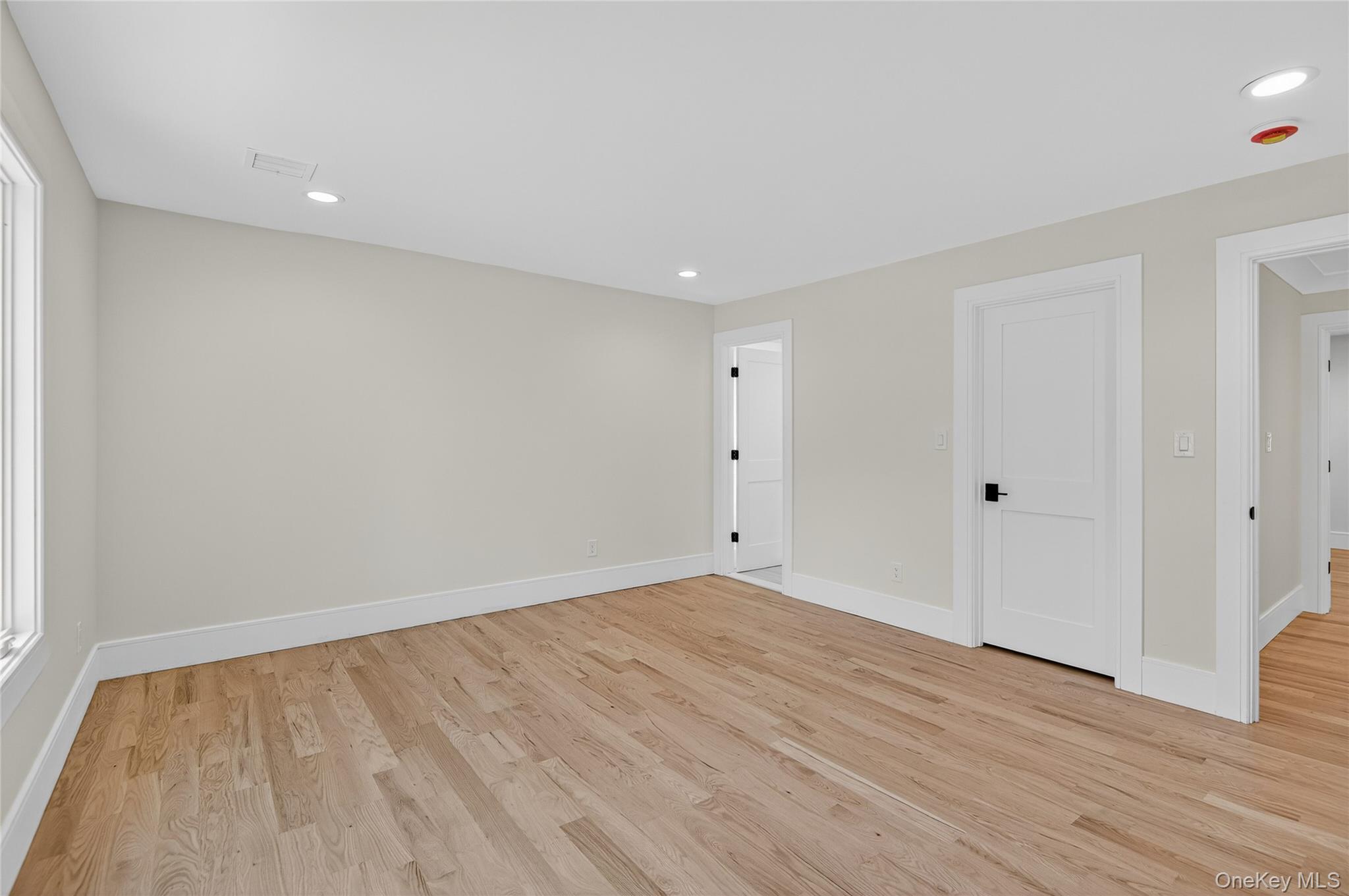 654 Caledonia Road Dix Hills, NY 11746 - Photo 26 of 42 Unfurnished room featuring recessed lighting and light wood-style flooring