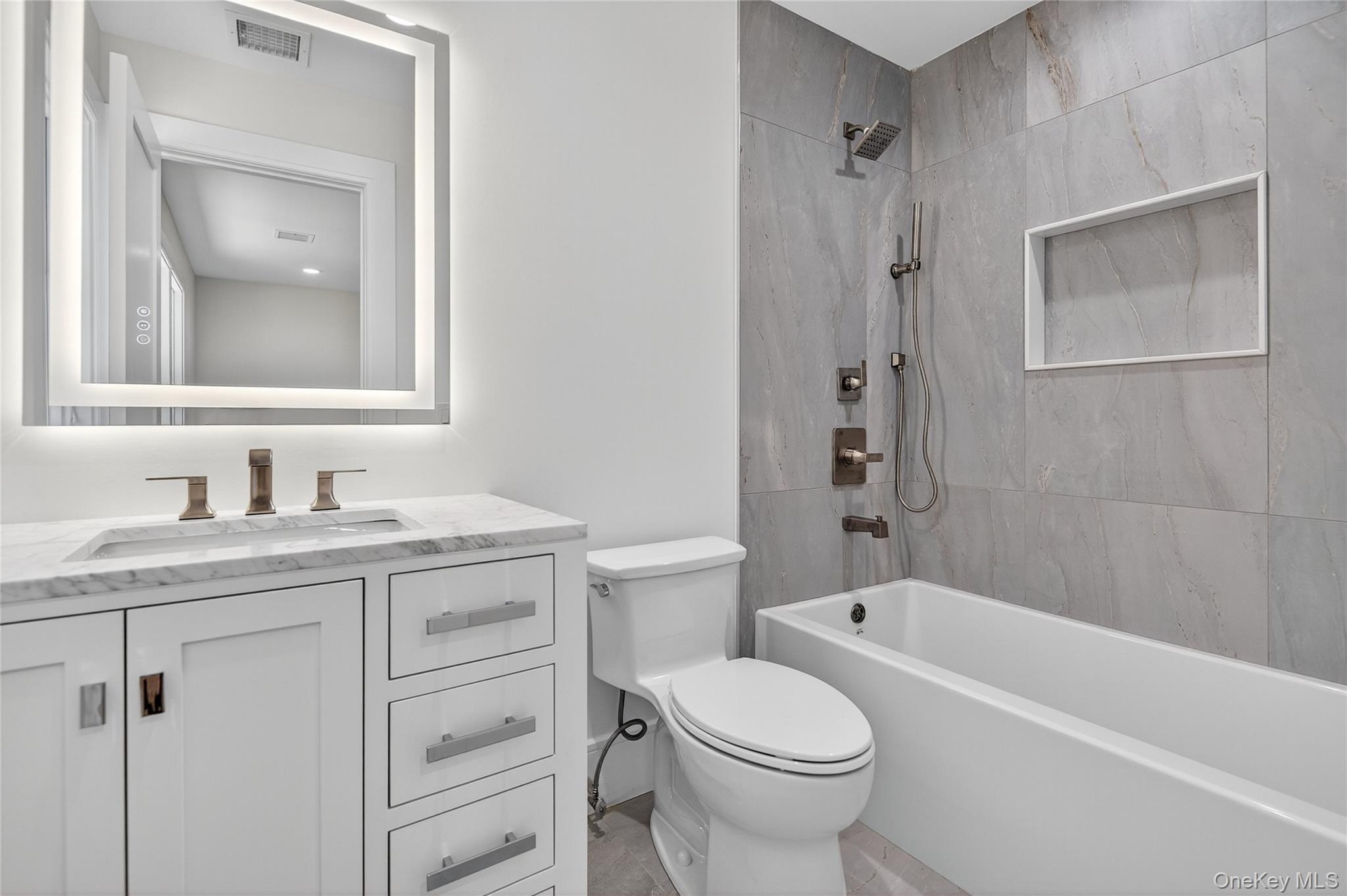 654 Caledonia Road Dix Hills, NY 11746 - Photo 31 of 42 Bathroom featuring tub / shower combination and vanity