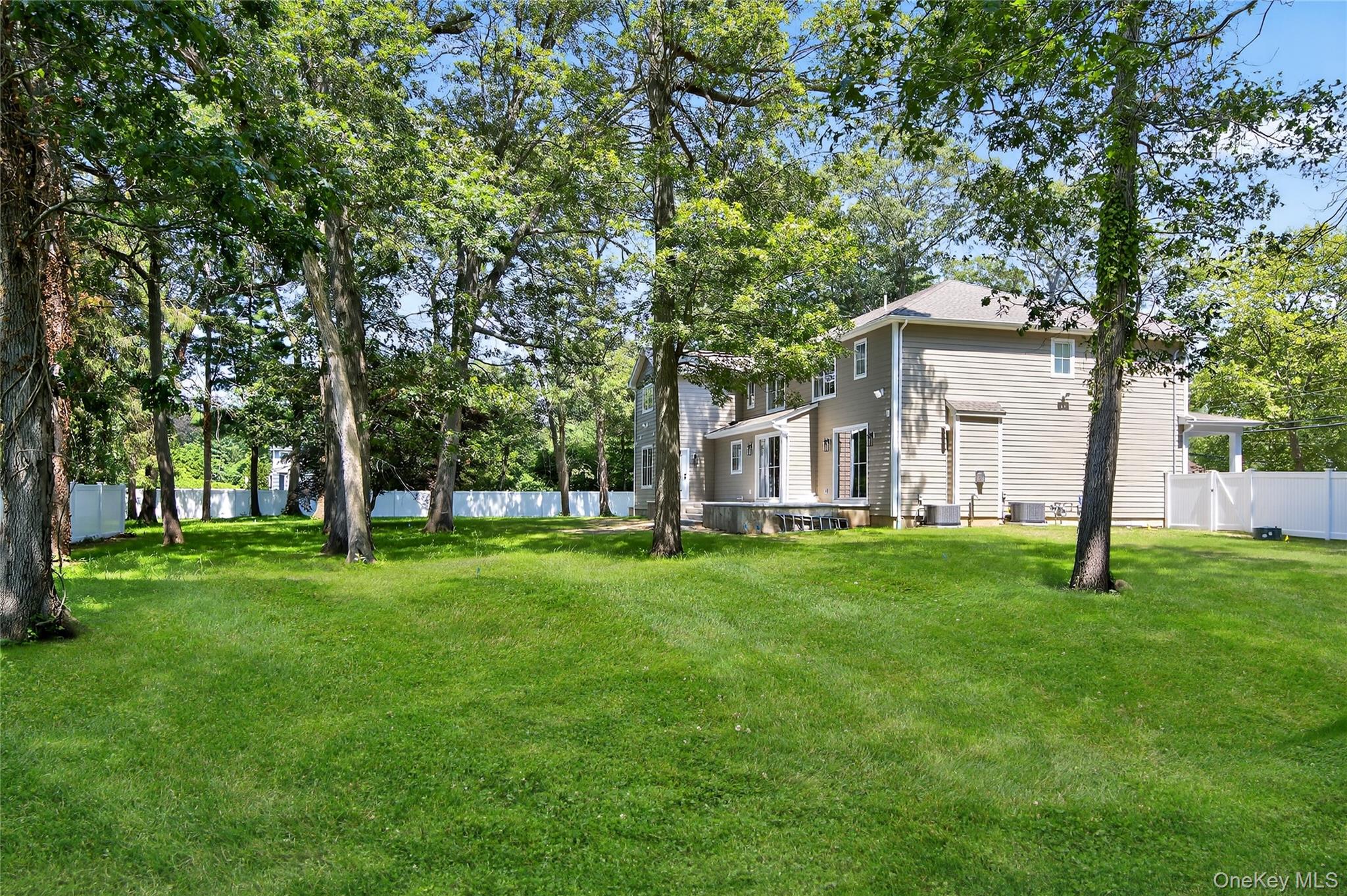 654 Caledonia Road Dix Hills, NY 11746 - Photo 38 of 42 Fenced backyard featuring view of scattered trees