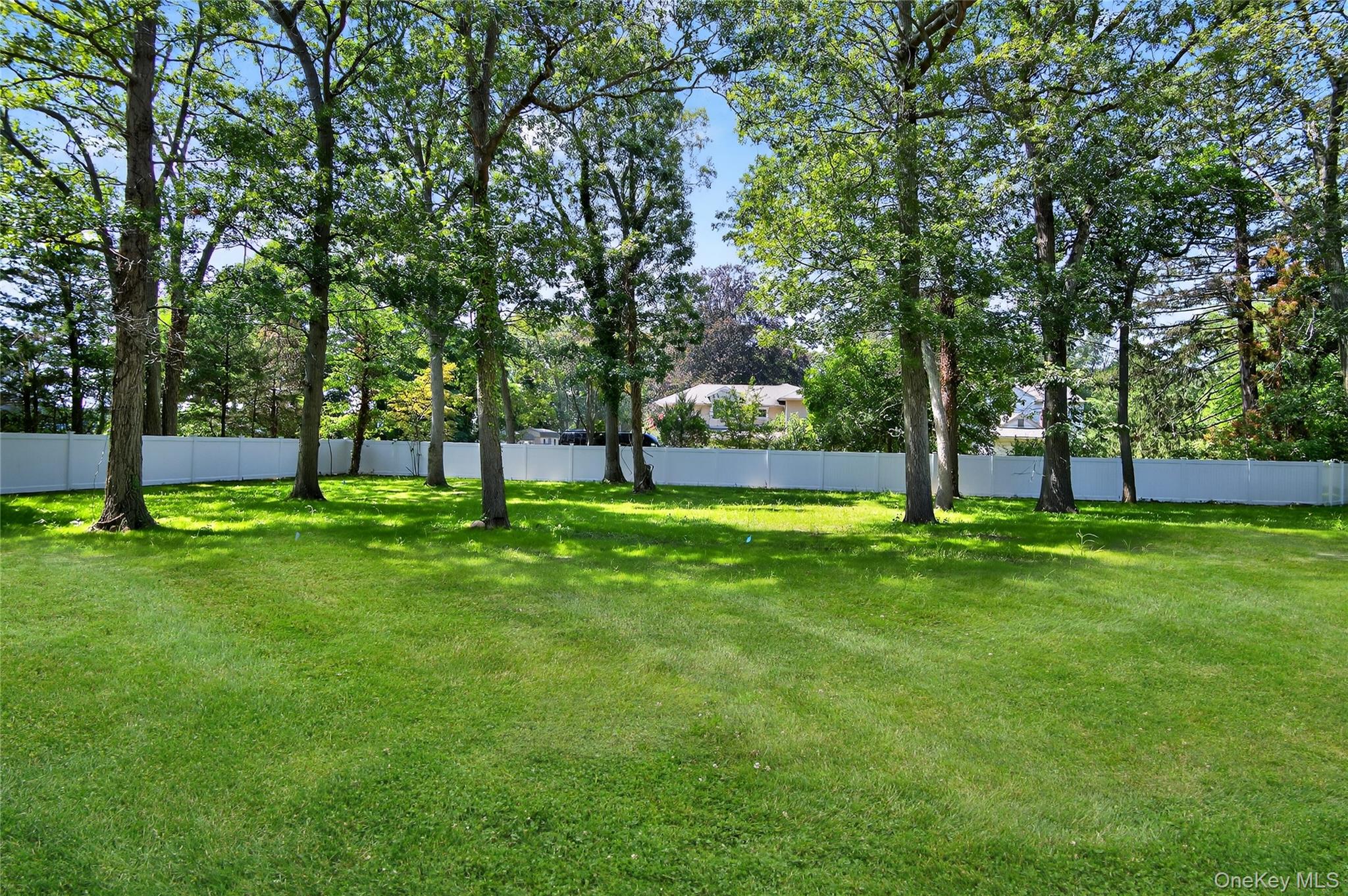 654 Caledonia Road Dix Hills, NY 11746 - Photo 39 of 42 View of yard with view of wooded area