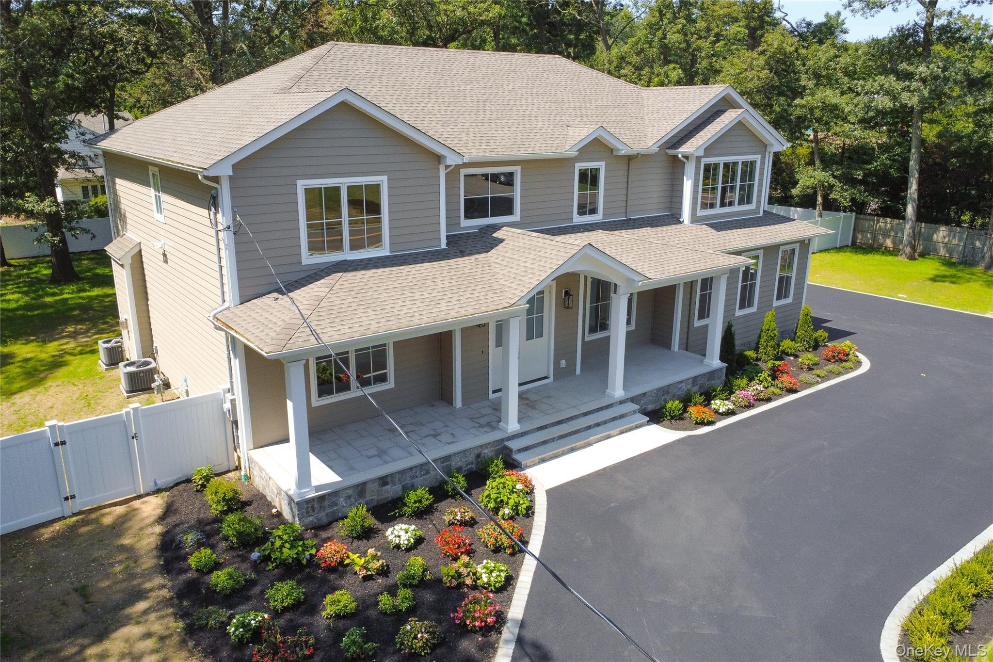 654 Caledonia Road Dix Hills, NY 11746 - Photo 41 of 42 View of front facade with a gate, a porch, a shingled roof, and view of wooded area
