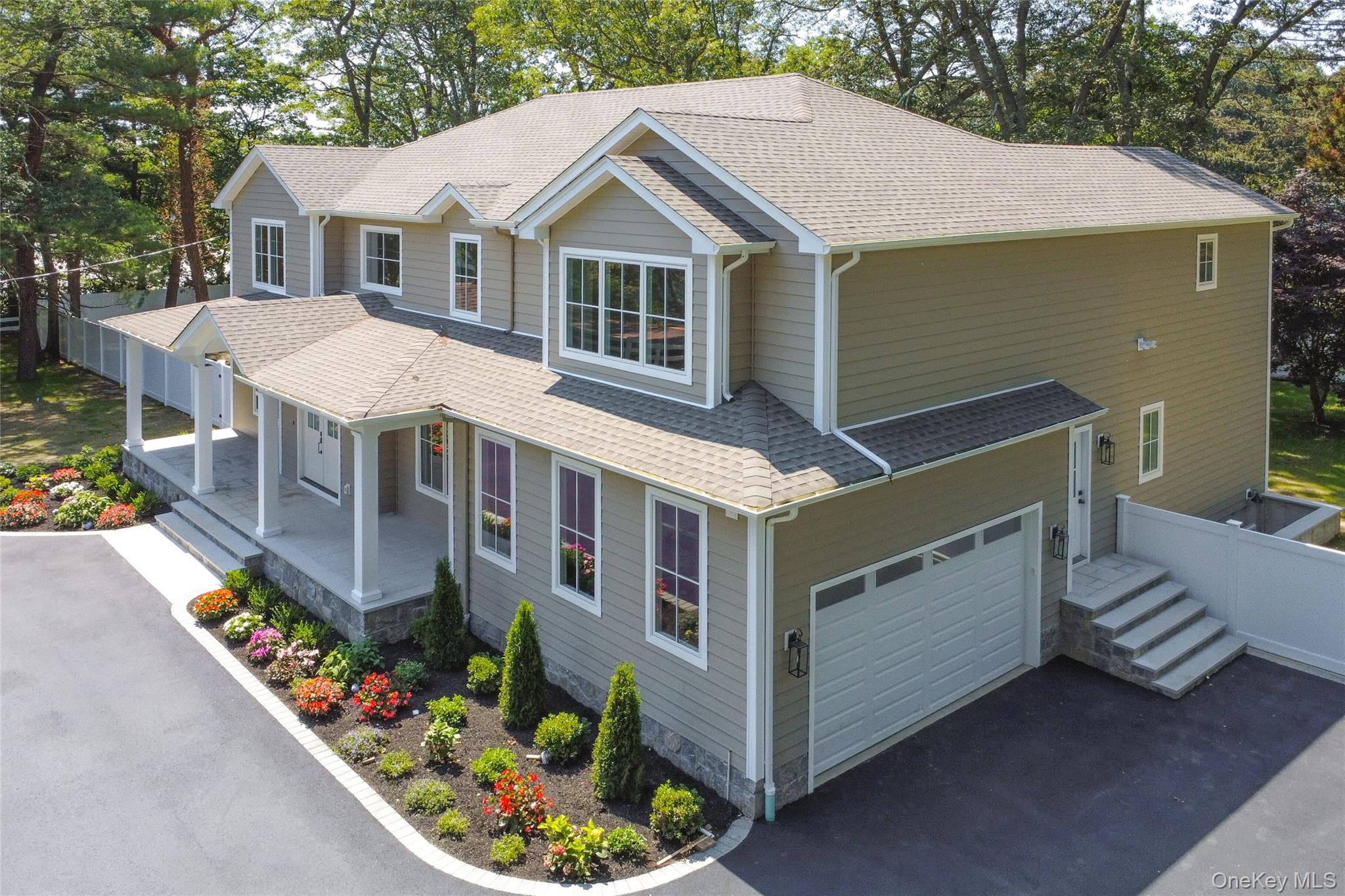 654 Caledonia Road Dix Hills, NY 11746 - Photo 42 of 42 View of front of home with a porch, driveway, and a shingled roof