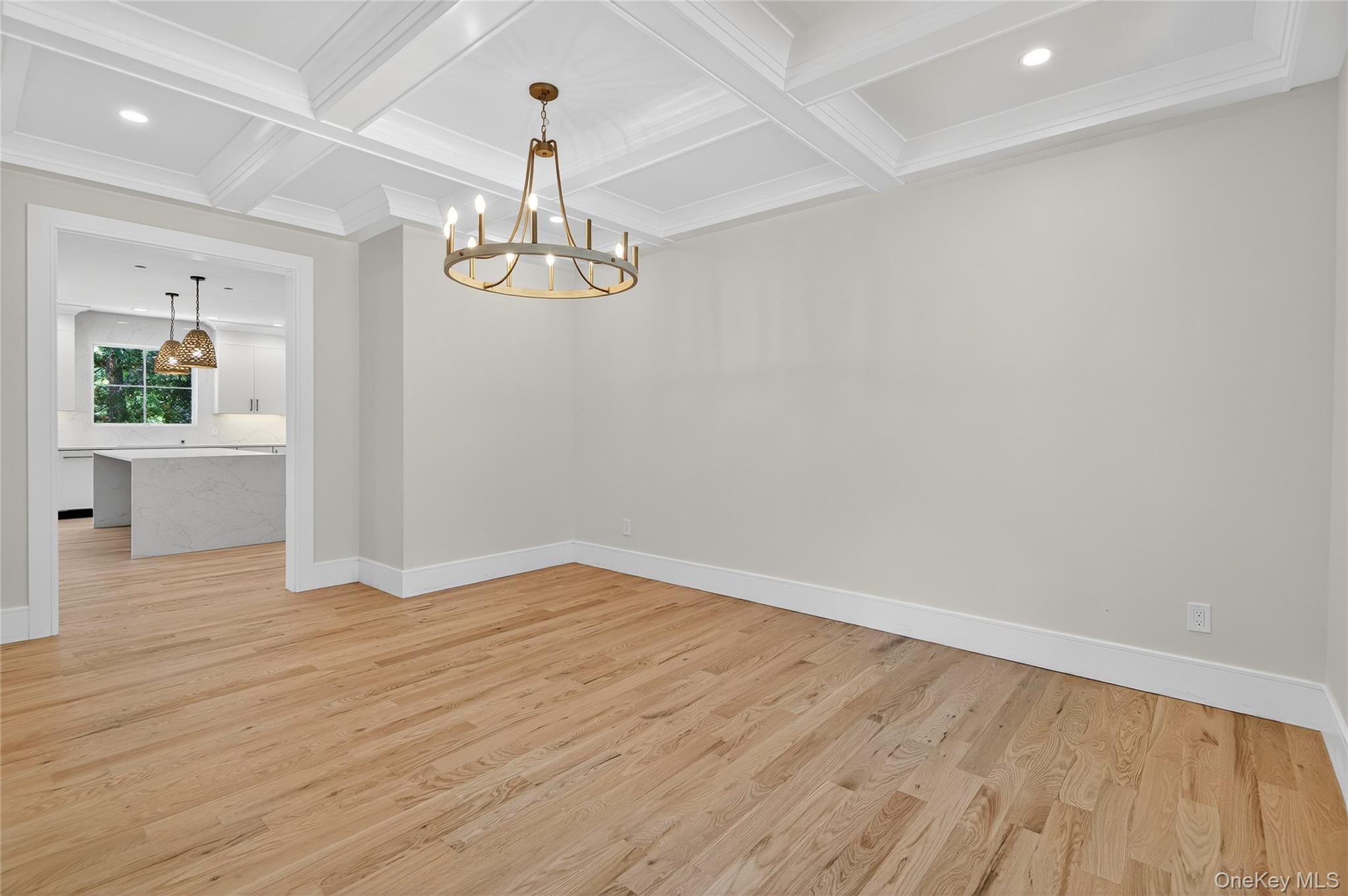 654 Caledonia Road Dix Hills, NY 11746 - Photo 7 of 42 Unfurnished dining area featuring recessed lighting, light wood finished floors, beam ceiling, a chandelier, and coffered ceiling