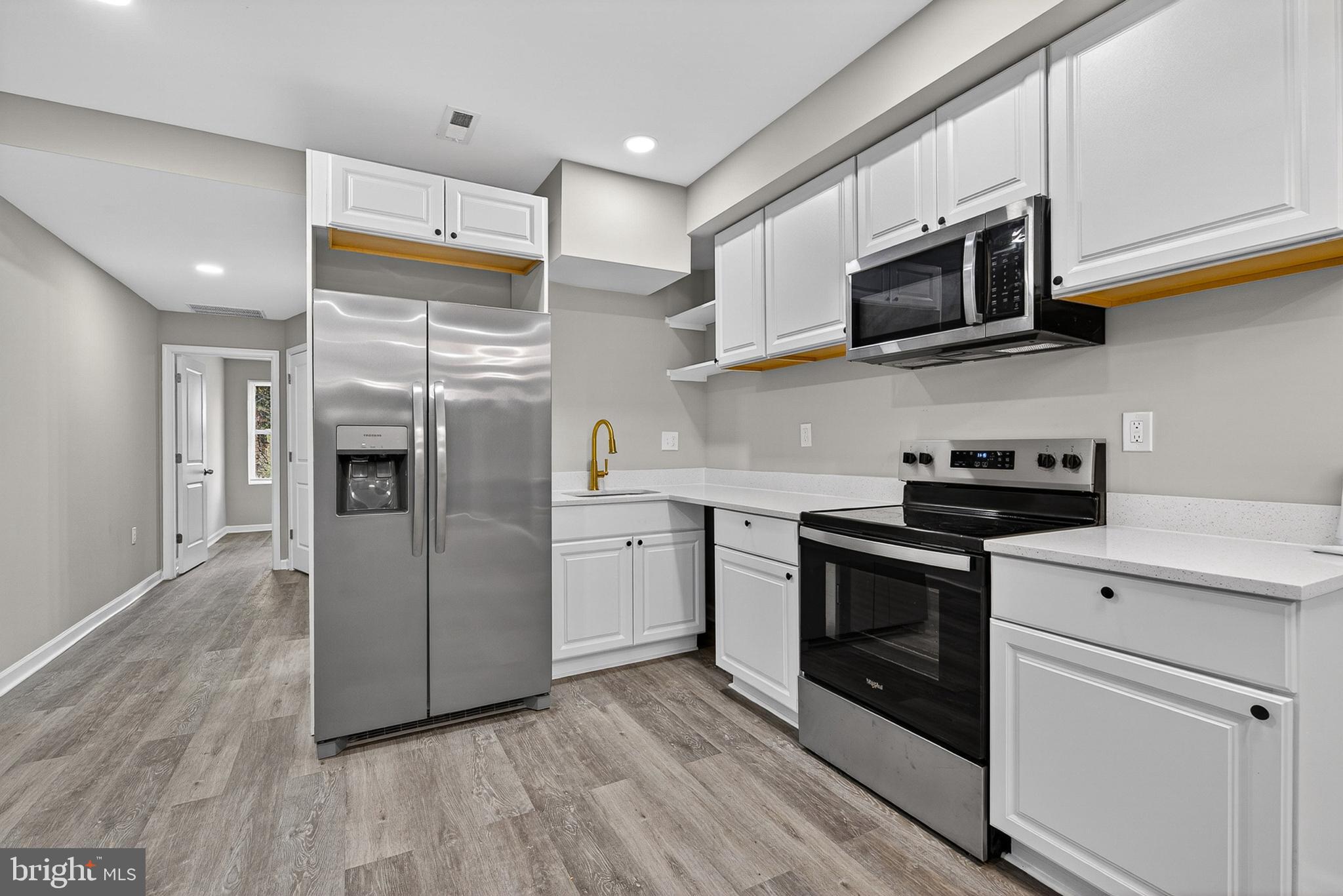 3708 Old Frederick Road Baltimore, MD 21229 - Photo 1 of 26 a kitchen with stainless steel appliances and wooden floor