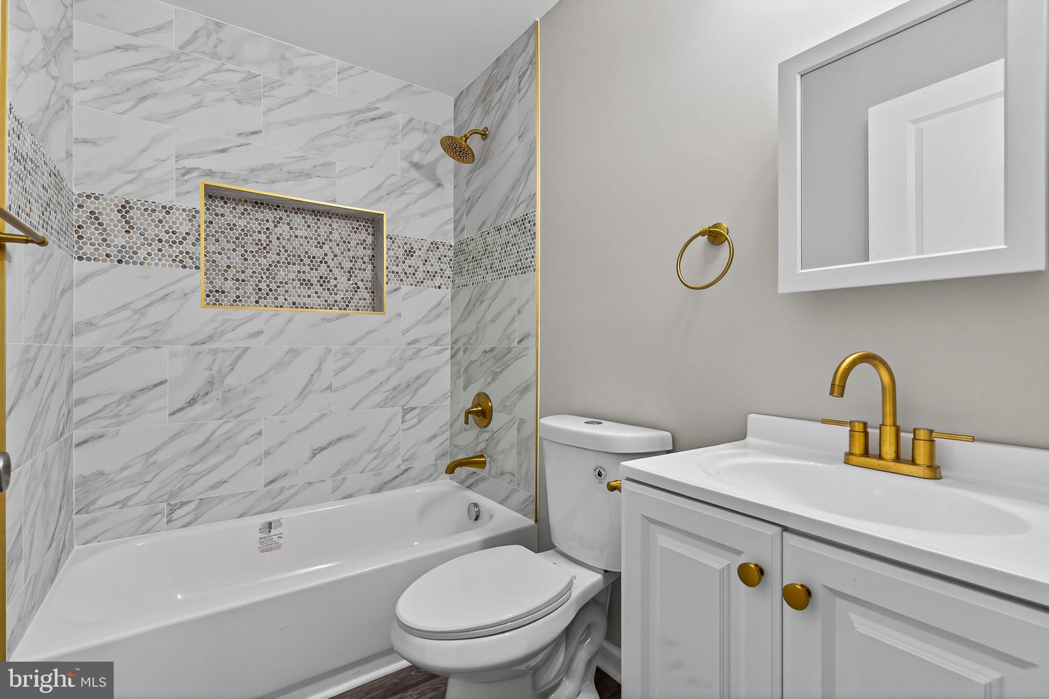 3708 Old Frederick Road Baltimore, MD 21229 - Photo 13 of 26 a white toilet sitting next to a bath tub