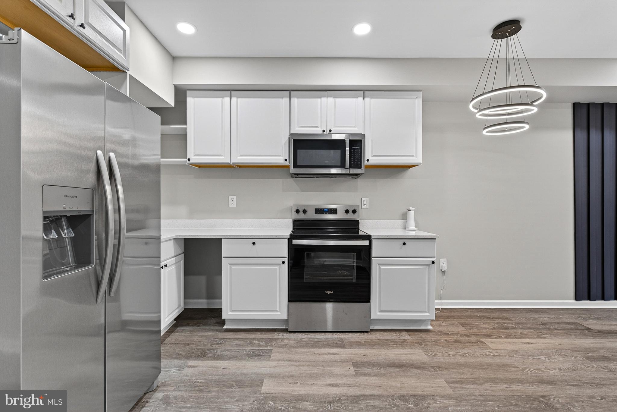 3708 Old Frederick Road Baltimore, MD 21229 - Photo 2 of 26 a kitchen with stainless steel appliances granite countertop a refrigerator and a stove top oven