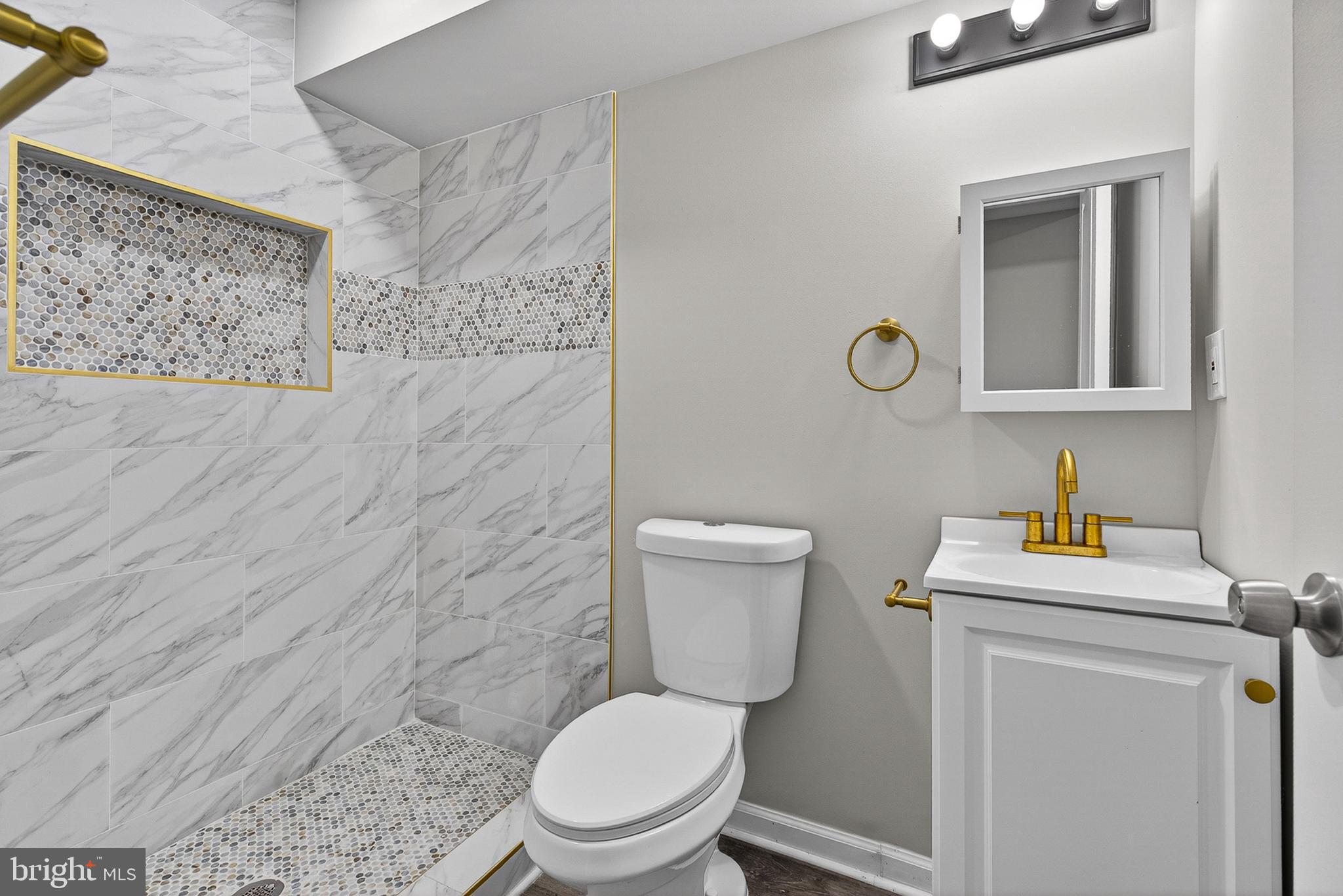 3708 Old Frederick Road Baltimore, MD 21229 - Photo 7 of 26 a white toilet sitting next to a bathroom sink