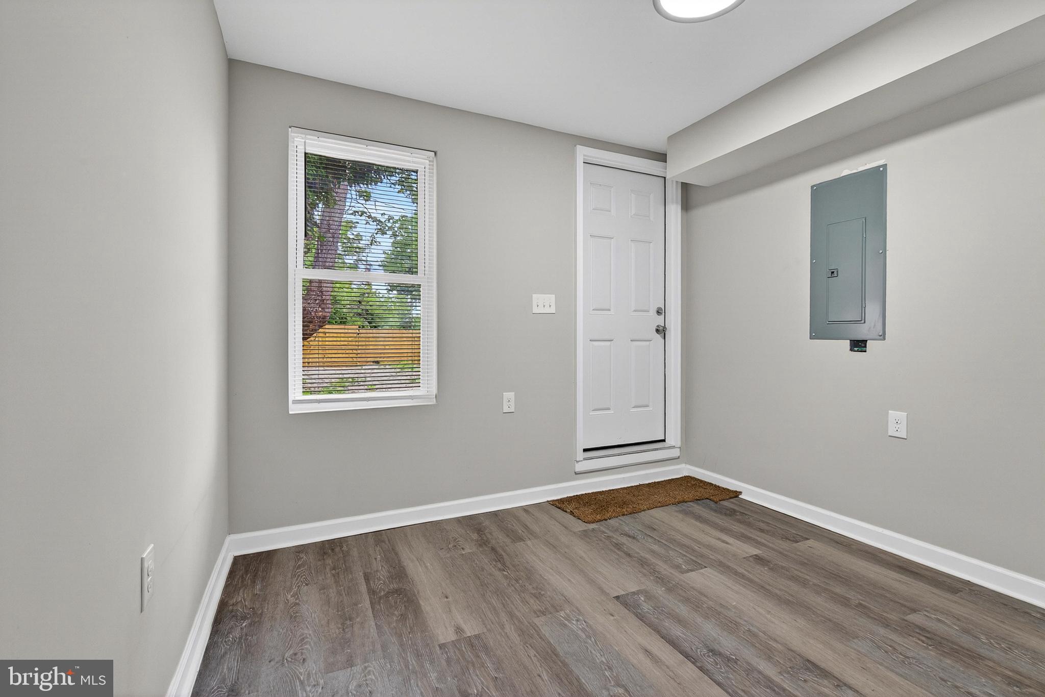 3708 Old Frederick Road Baltimore, MD 21229 - Photo 9 of 26 an empty room with wooden floor and windows