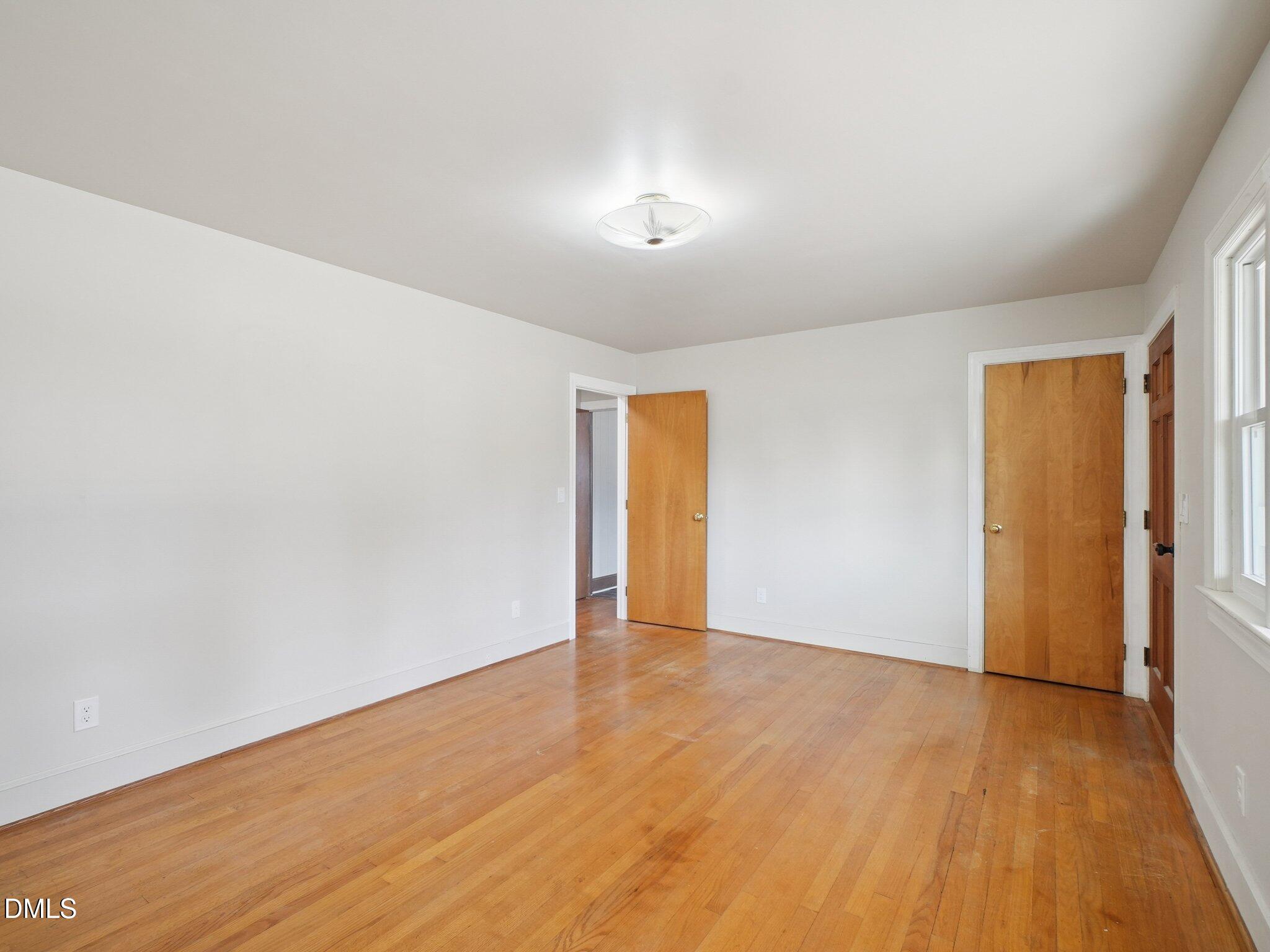 5474 Deans Road Battleboro, NC 27809 - Photo 12 of 32 a view of an empty room with wooden floor and a window