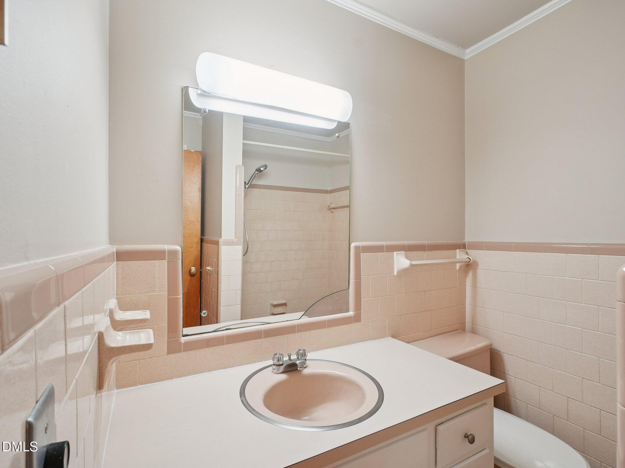 5474 Deans Road Battleboro, NC 27809 - Photo 16 of 32 a bathroom with a sink and a mirror