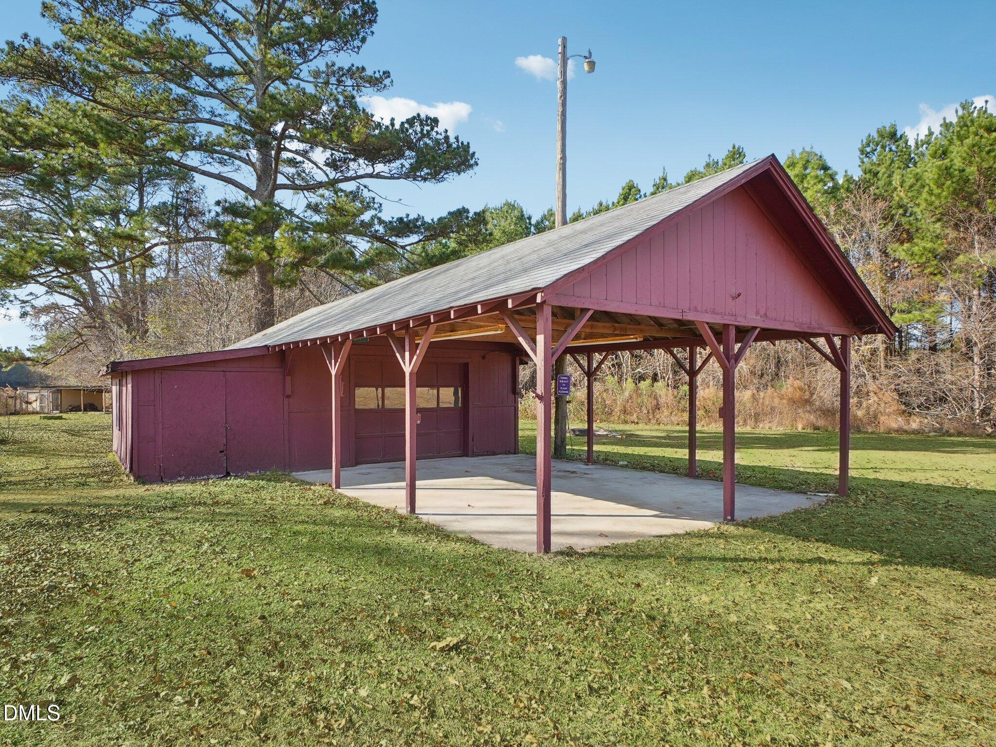 5474 Deans Road Battleboro, NC 27809 - Photo 24 of 32 a backyard of a house with table and chairs
