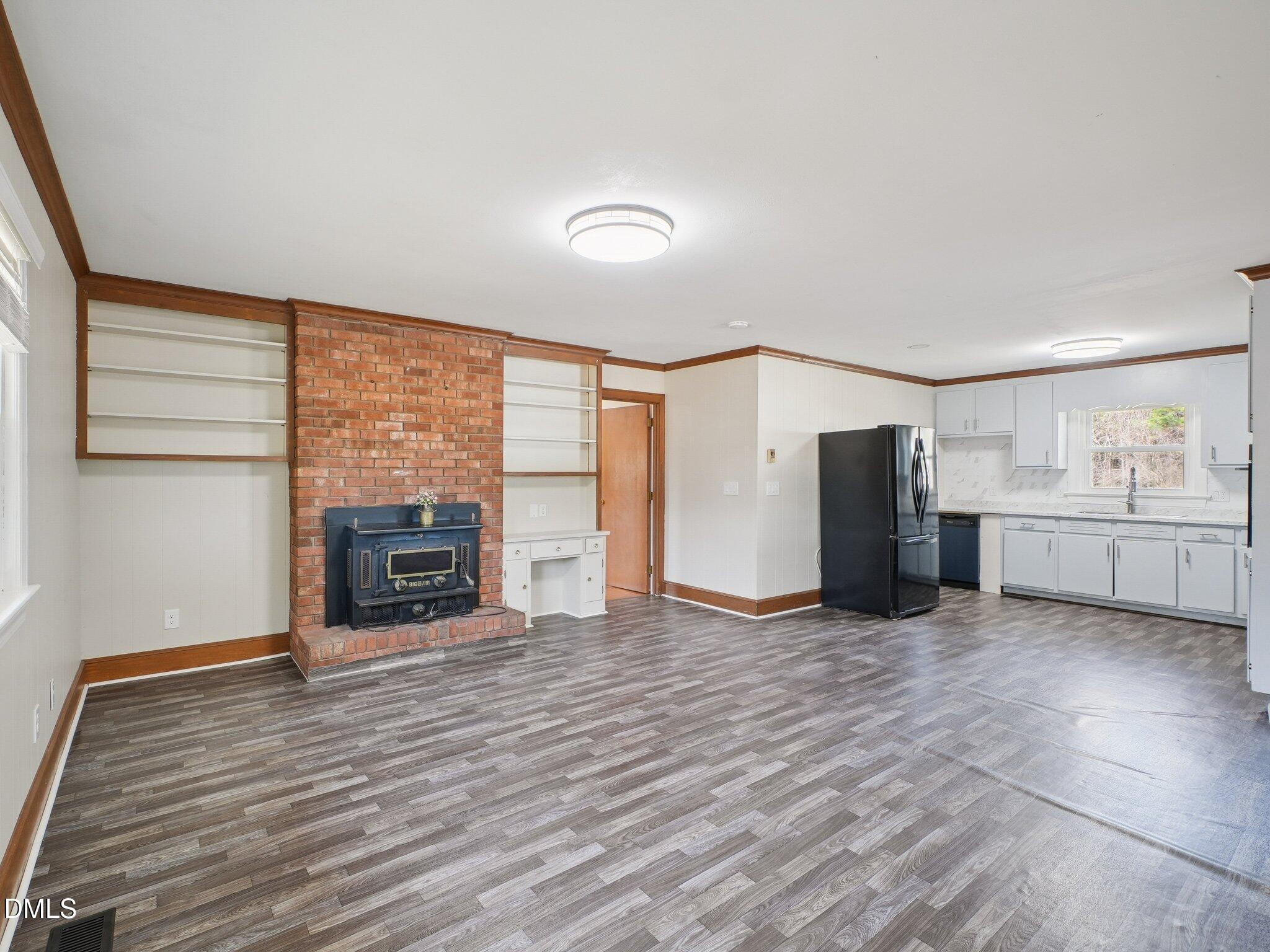5474 Deans Road Battleboro, NC 27809 - Photo 4 of 32 a view of an empty room with a fireplace and a window