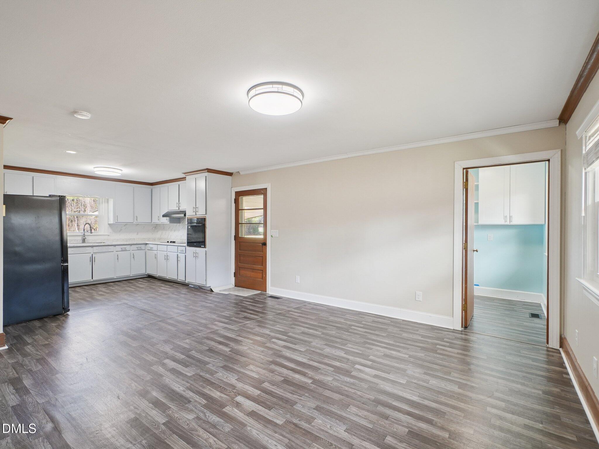 5474 Deans Road Battleboro, NC 27809 - Photo 5 of 32 an empty room with wooden floor and windows