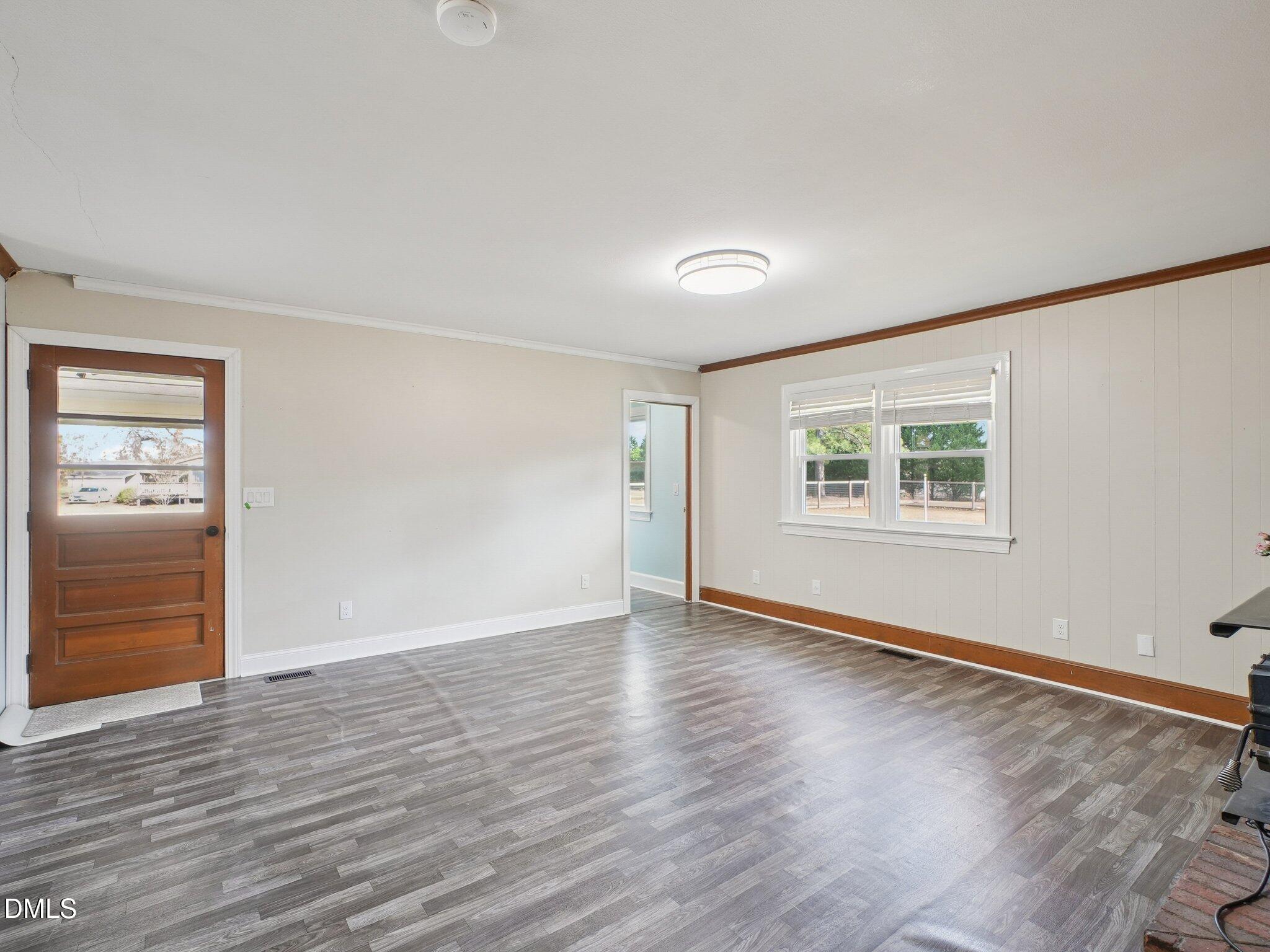 5474 Deans Road Battleboro, NC 27809 - Photo 6 of 32 an empty room with wooden floor and windows