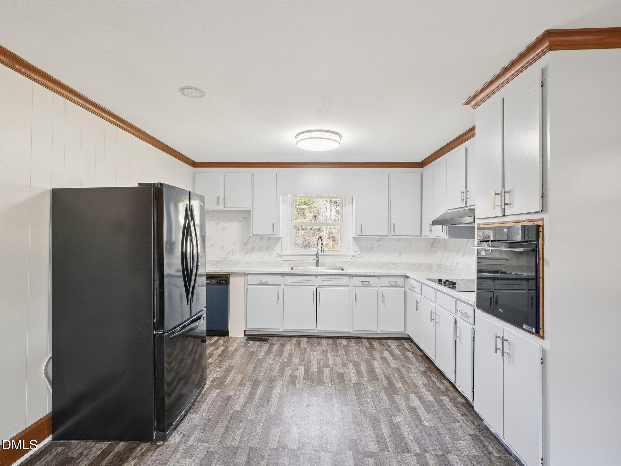 5474 Deans Road Battleboro, NC 27809 - Photo 7 of 32 a kitchen with granite countertop white cabinets and stainless steel appliances