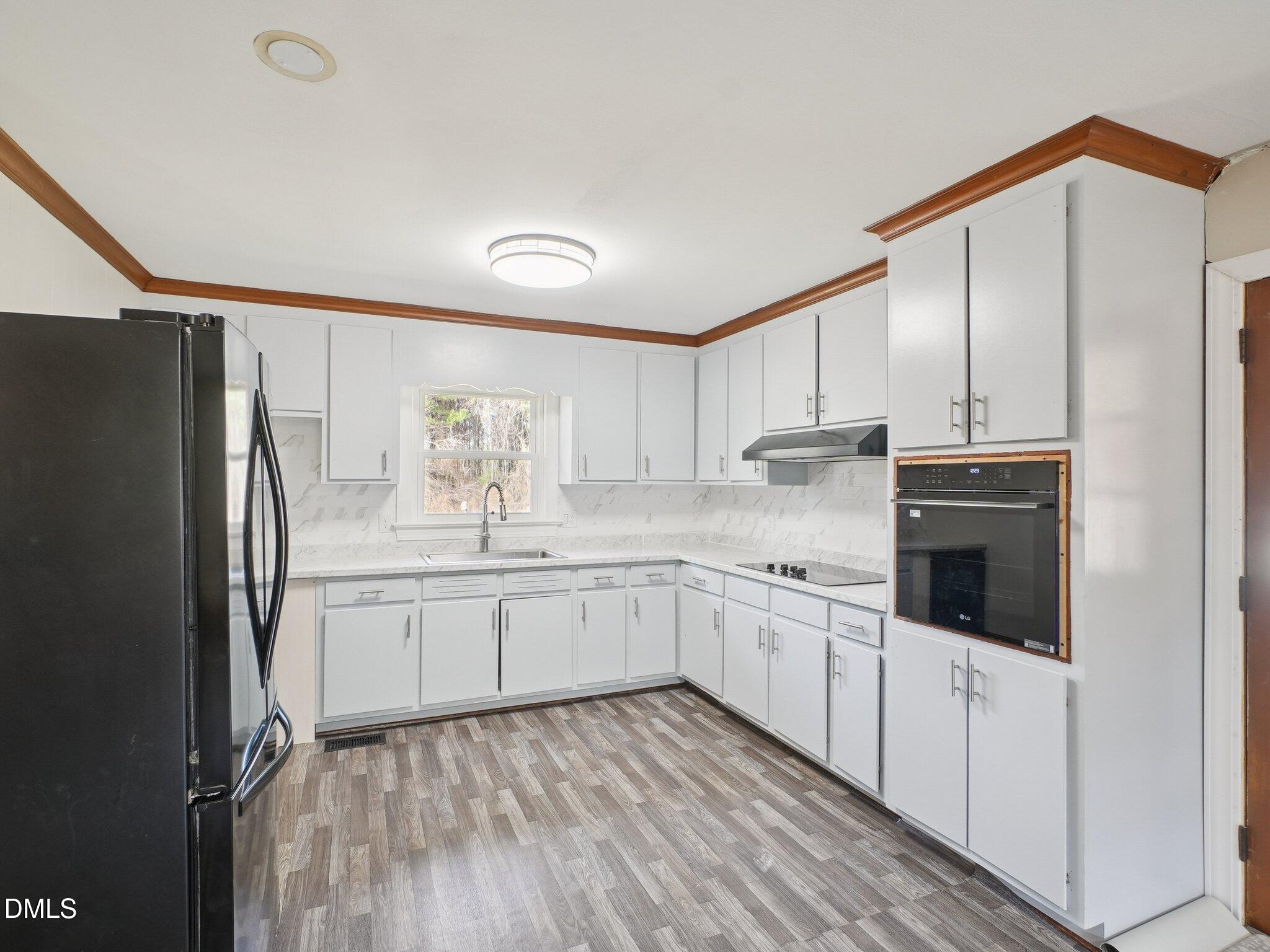5474 Deans Road Battleboro, NC 27809 - Photo 9 of 32 a kitchen with stainless steel appliances a refrigerator sink and cabinets