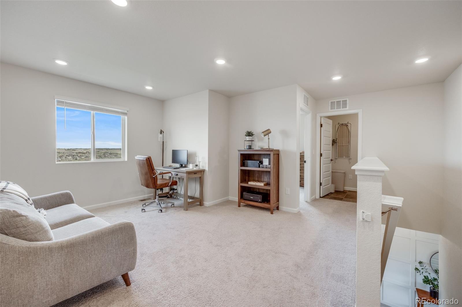 4811 River Highlands Loop Elizabeth, CO 80107 - Photo 15 of 37 a living room with furniture and a chair