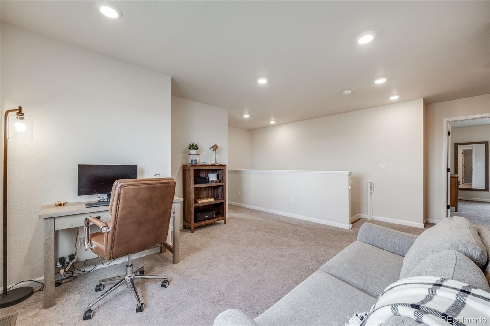 4811 River Highlands Loop Elizabeth, CO 80107 - Photo 16 of 37 a view of a livingroom with workspace and a couch