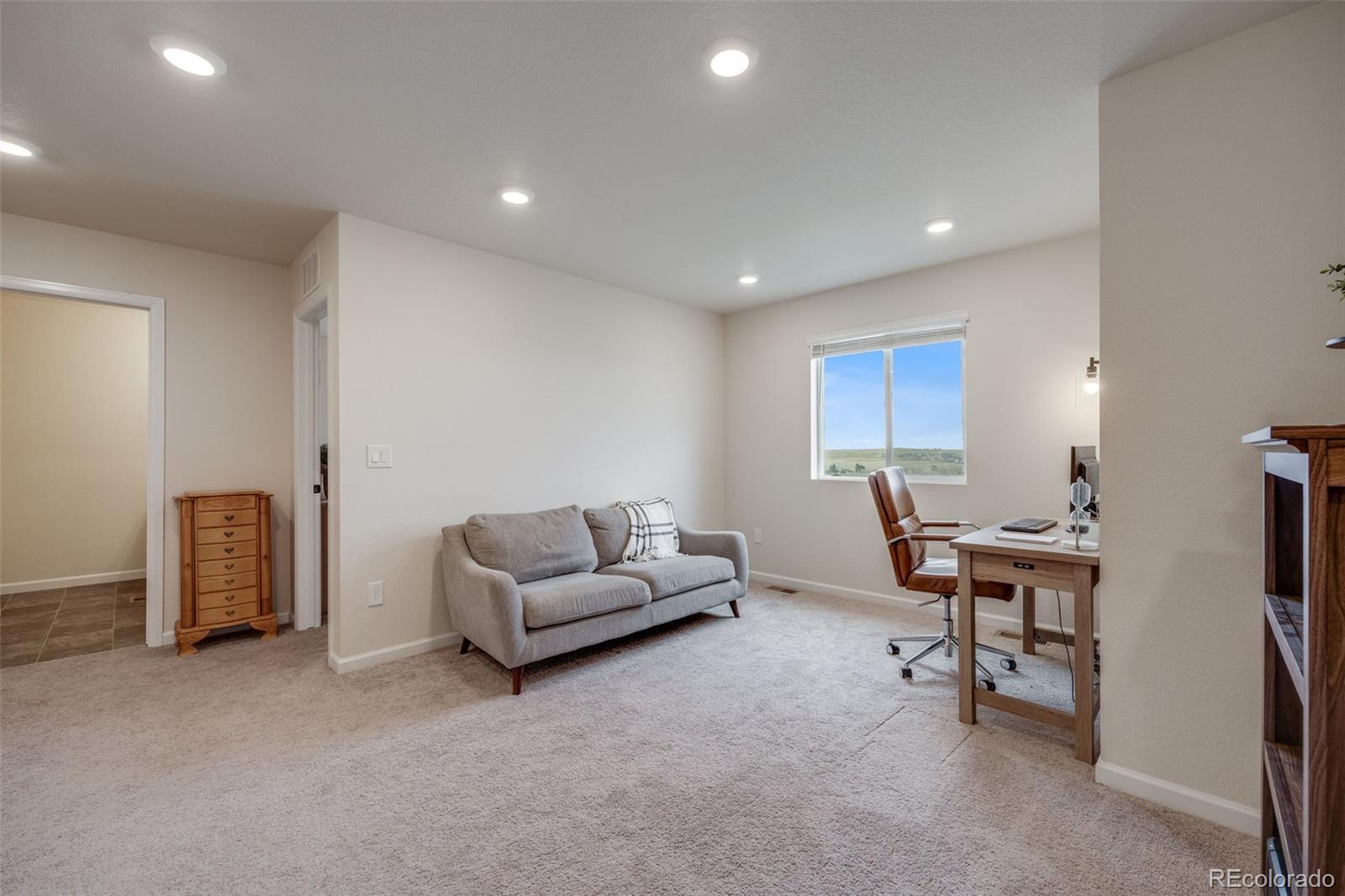 4811 River Highlands Loop Elizabeth, CO 80107 - Photo 17 of 37 a living room with furniture and a window