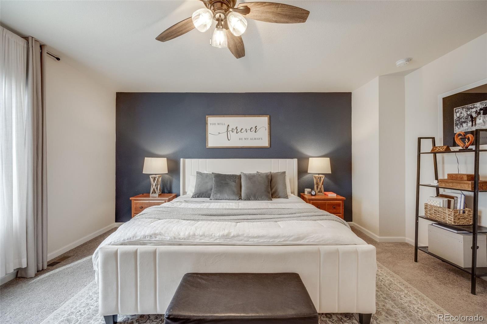 4811 River Highlands Loop Elizabeth, CO 80107 - Photo 20 of 37 a bedroom with a bed and a chandelier