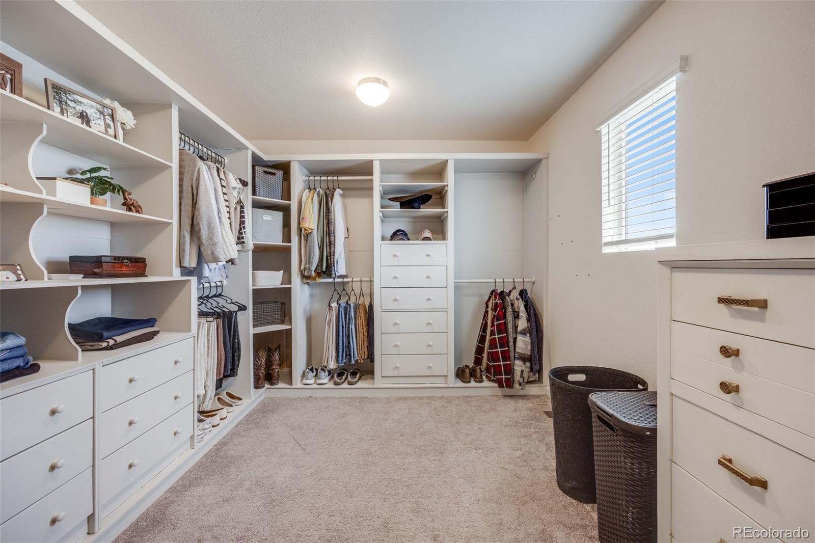 4811 River Highlands Loop Elizabeth, CO 80107 - Photo 22 of 37 a view of walk in closet with clothes and shoes