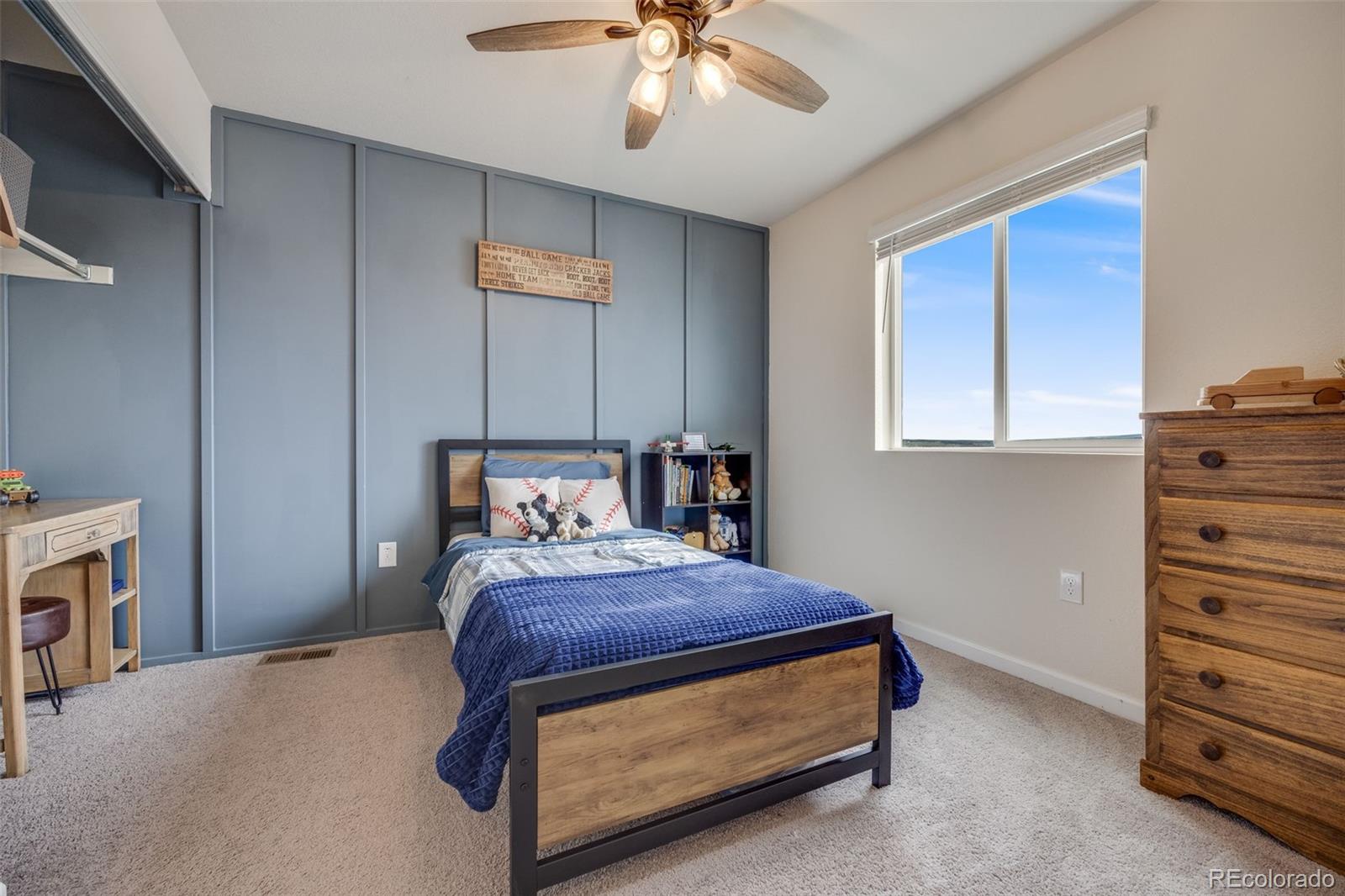 4811 River Highlands Loop Elizabeth, CO 80107 - Photo 25 of 37 a bedroom with a bed and a chandelier