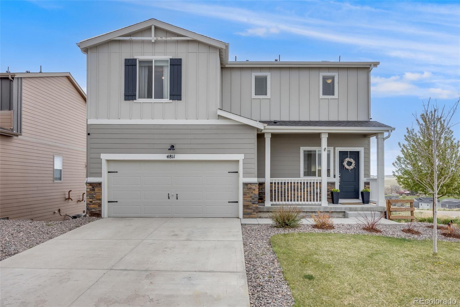 4811 River Highlands Loop Elizabeth, CO 80107 - Photo 3 of 37 a front view of a house with a garden