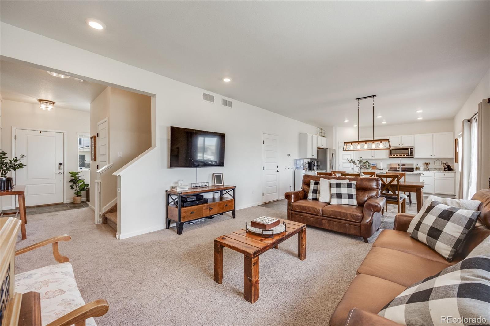 4811 River Highlands Loop Elizabeth, CO 80107 - Photo 6 of 37 a living room with furniture and a flat screen tv