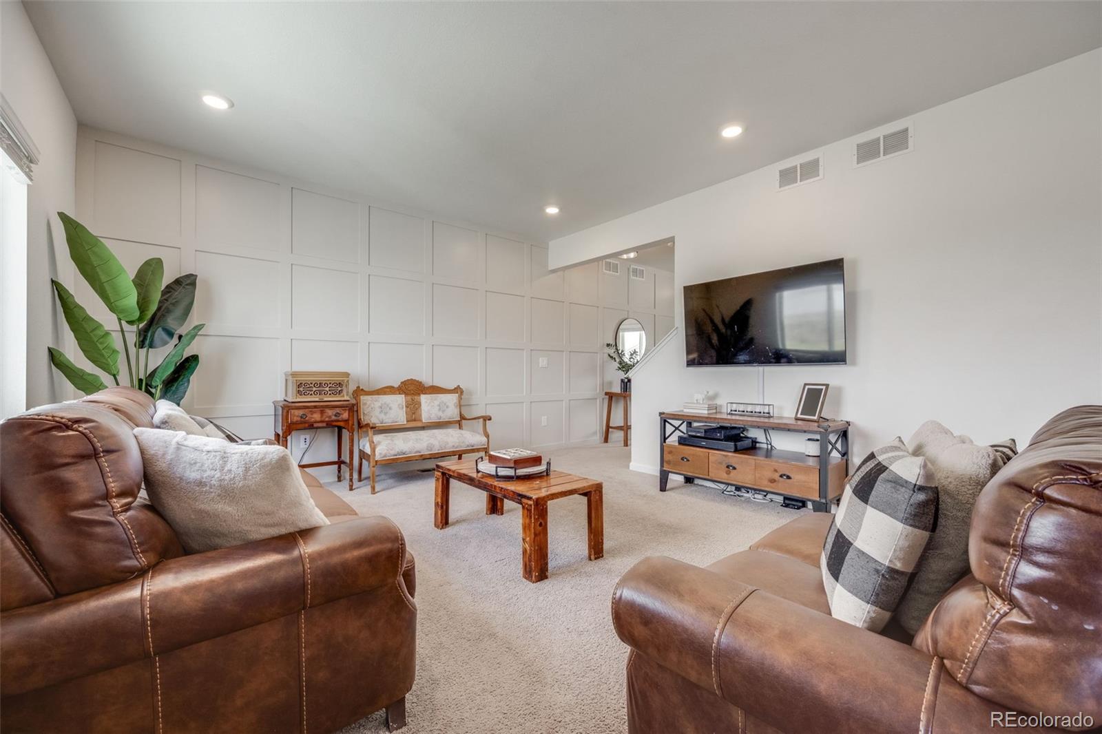 4811 River Highlands Loop Elizabeth, CO 80107 - Photo 8 of 37 a living room with furniture and a flat screen tv