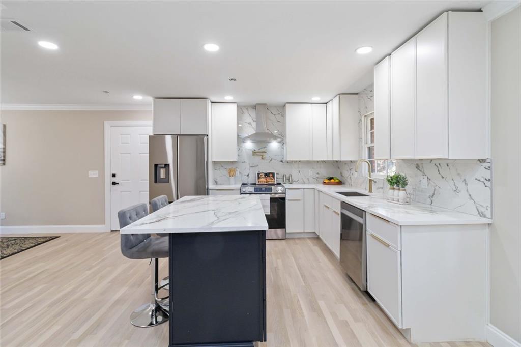 2927 Ponderosa Circle Decatur, GA 30033 - Photo 3 of 27 a kitchen with stainless steel appliances granite countertop a refrigerator a sink dishwasher a stove and white countertops with wooden floor