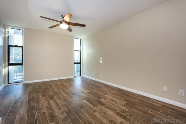 wooden floor in an empty room with a window