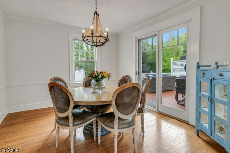 122 Kenilworth Road Mountain Lakes, NJ 07046 - Photo 20 of 45 a dining room with furniture a chandelier and wooden floor